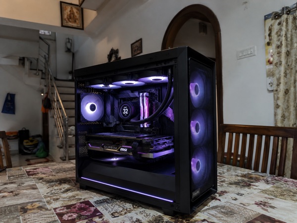 A Rebyte technician’s finished custom PC build on a customer’s dining table in Chennai
